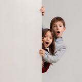 banner-with-surprised-children-peeking-edge_155003-10104