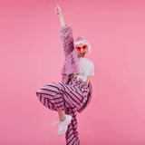 blissful-woman-wears-striped-pants-pink-periwig-laughing-during-photos