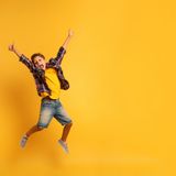 happy-child-jumping-yellow-background_207634-444